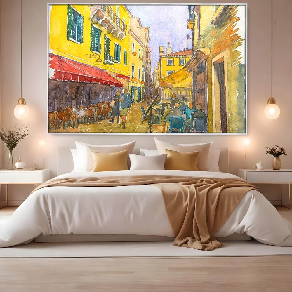 Tablou canvas cu pictura acuarela strada cu terase, in rama de aluminiu argintiu, pe perete intr-un dormitor